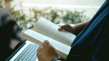 Enjoy a relaxing day by reading a good book, sitting on the windowsill.の写真素材
