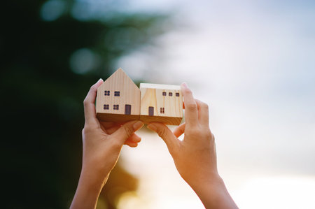 The sunlight streamed into the wooden house, gleaming brightly, reflecting the power of home buying and construction, demonstrating cooperation and teamwork.の写真素材