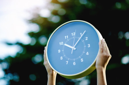 A clock tells the story of life and work, enabling optimal time management. A close-up photograph of time.の写真素材