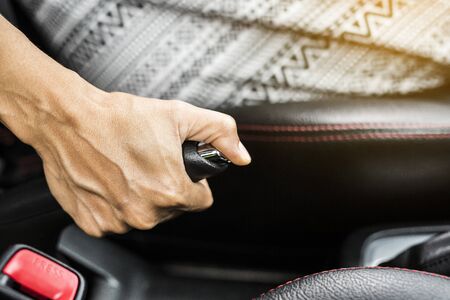 Women sitting in the car are using hand brake.Concept of car safetyの写真素材