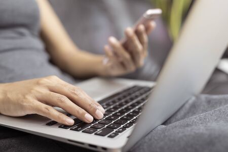 Working woman is working with a smart phone and computer. The concept of women working with...