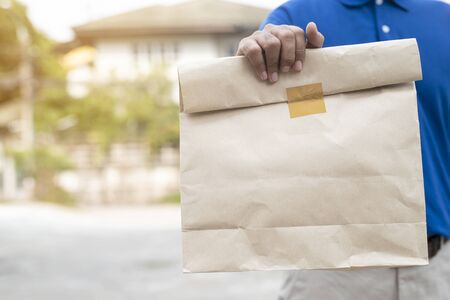 Young man holding paper containers for takeaway food,Food delivery concept..の写真素材