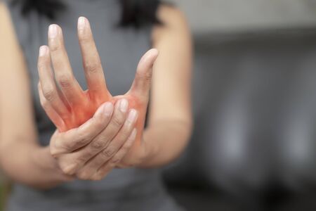 Woman with pain in his hand because of hard work, Ache in human body , office syndrome,Bone and joint disease, Concept healthcare and medical.の写真素材