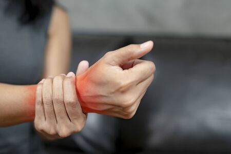 Woman with pain in his hand because of hard work, Ache in human body , office syndrome,Bone and...