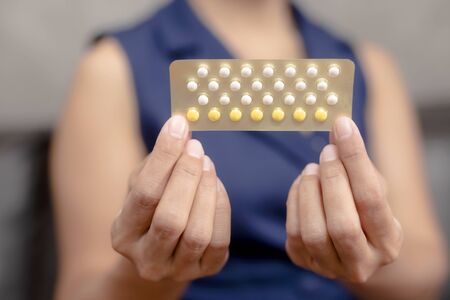 Woman holding combined oral contraceptive pill.Gynecology concept.の写真素材