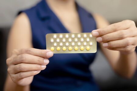 Woman holding combined oral contraceptive pill.Gynecology concept.の写真素材