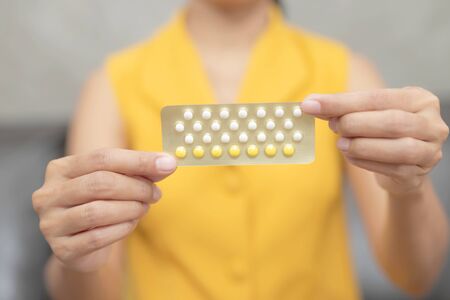 Woman holding combined oral contraceptive pill.Gynecology concept.の写真素材