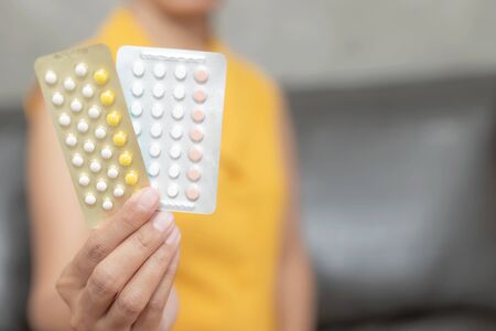 Woman holding combined oral contraceptive pill.Gynecology concept.の写真素材