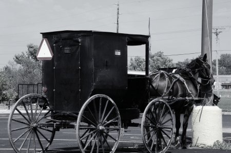 Old Tied to New - Amish Buggy Tied to Power Line in Wisconsinの写真素材