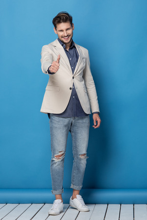 Happy handsome man over blue backgroundの写真素材