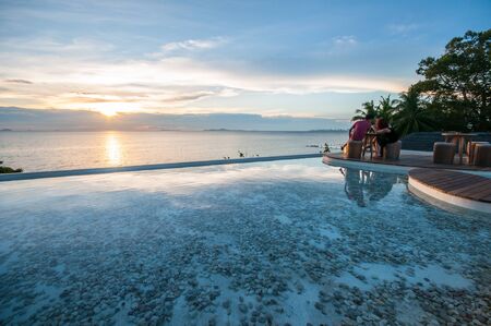 Dining by the pool watching sunsetのeditorial素材