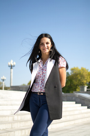Beautiful Young Woman Outdoors. Enjoy Nature. Healthy Smiling Girl in Cityの写真素材