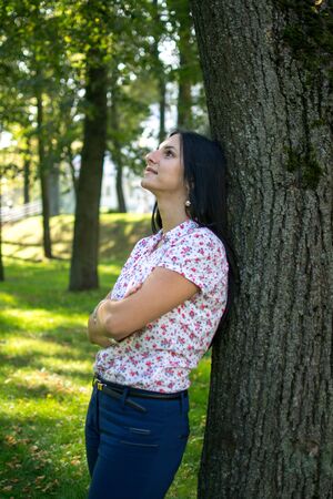 Beautiful Young Woman Outdoors. Enjoy Nature. Healthy Smiling Girl in Green Grass.の写真素材