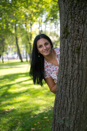 Beautiful Young Woman Outdoors. Enjoy Nature. Healthy Smiling Girl in Green Grass.の写真素材