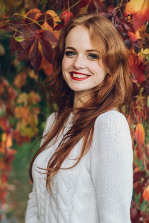 Portrait of happy beautiful redhaired girl smiling.の写真素材