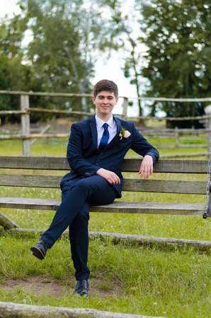 A beautiful married man in costume, posing for a photo shooting in an belarusian village. Green background.の写真素材