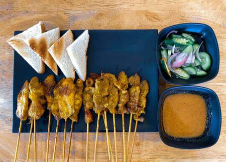 High angle view of beef and chicken grilled calls satay on the tableの写真素材