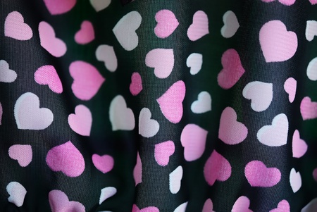 The colorful heart texture on a black fabric 