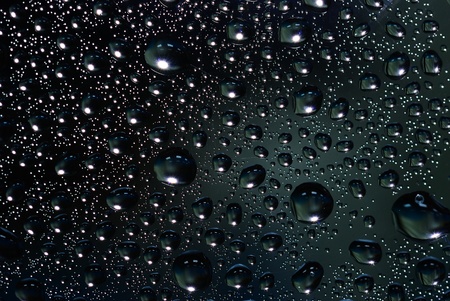 The dark water drop on the glass backgroundの写真素材