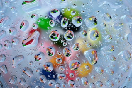 Many candy in water drop on glass background
