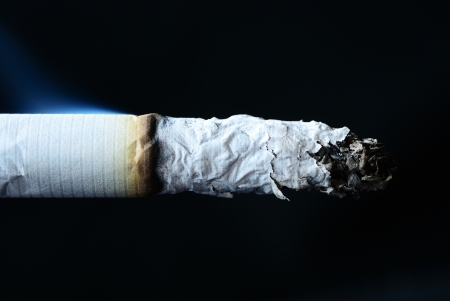 Close up on the cigarette with  isolated blackの写真素材