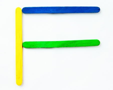 Colorful wood bar separated to F consonant on isolated whiteの写真素材