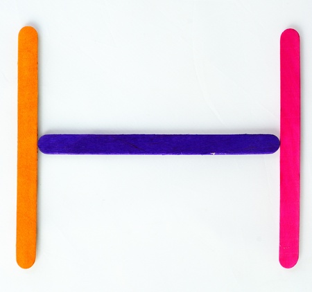 Colorful wood bar separated to H consonant on isolated whiteの写真素材