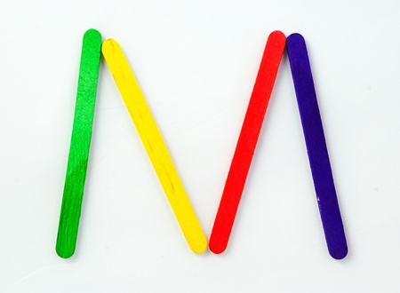 Colorful wood bar separated to M consonant on isolated whiteの写真素材
