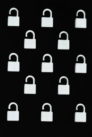 Many white lock on black color backgroundの写真素材