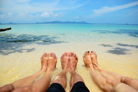 One man and two girl feelfree on the beachの写真素材