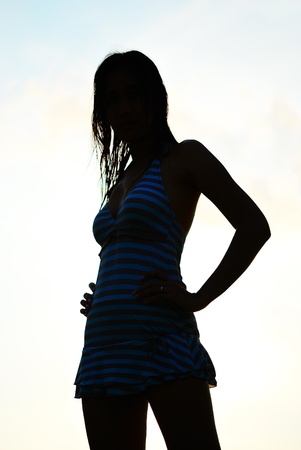 Silhouette of Asian woman in swimming suiteの写真素材