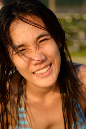 Smile of Thailand on the beach by Thai womanの写真素材