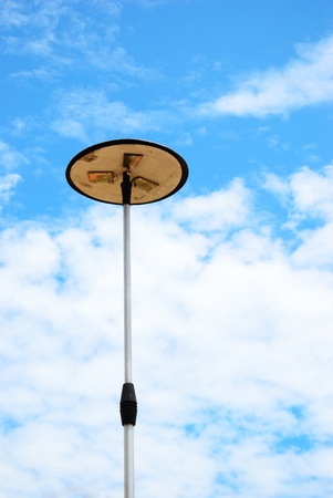 Lonely light pole with cloud and blue sky backgroundの写真素材