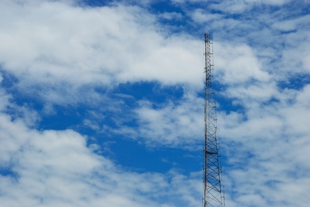 Telecommunication post in cloudy day and blue skyの写真素材
