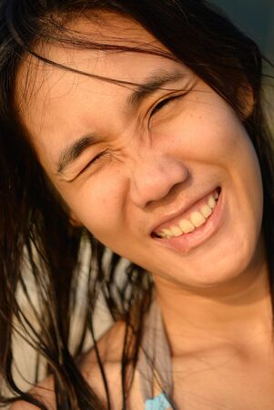 Asian woman close her eye by sunny in the eveningの写真素材