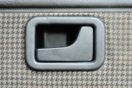 Door lock handle with the old fabric background