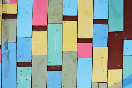 Colorful wood separated on plywood wall backgroundの写真素材