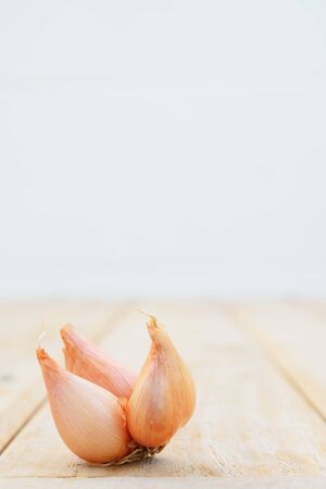Still life shot of orange onion on wood tableの写真素材