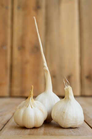 Still life shot of tripple garlic on wood の写真素材