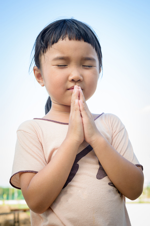 Thai girl praying and close her eye for something の写真素材
