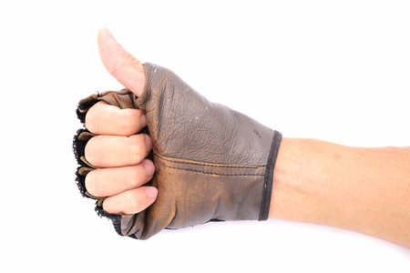Hand with leather glove thumb up on isolated white