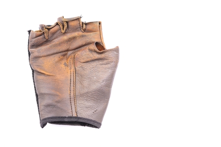 Old leather gloves on isolated white backgroundの写真素材