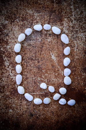 Alphabet made form white stone on rustry floor background.の写真素材
