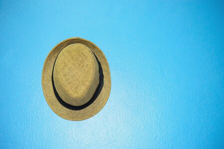 Vintage hat with black ribbon on blue vintage wallの写真素材