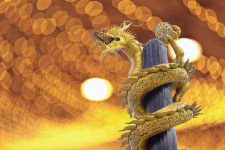 Golden dragon build from gear on Bokeh backgroundの写真素材