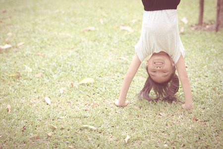 Asian kid playing with relax pose in the green gardenの写真素材