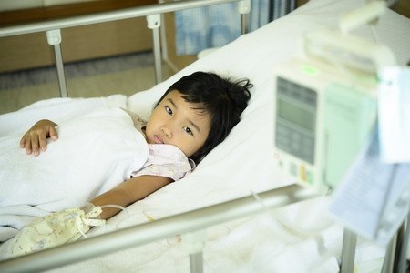 Kid sick in the hospital with salineの写真素材