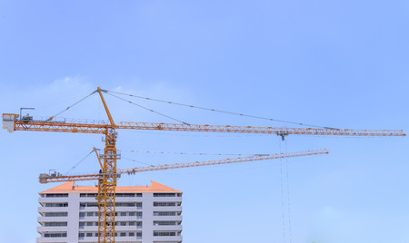 Working crane in construction site with clear skyの写真素材