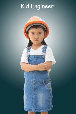 A serious mood of little engineer after inspected the building on isolated dark backgroundの写真素材