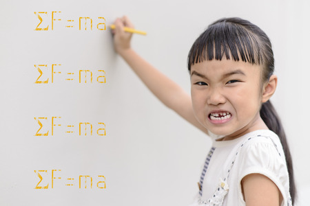 Kid shout and writing yellow scientific formula on the wall